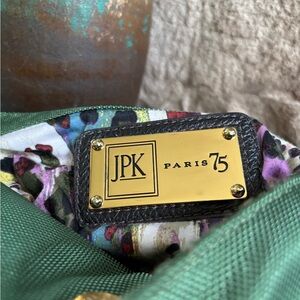 JPK Paris 75 green bucket bag with leather strap and gold tone hardware.